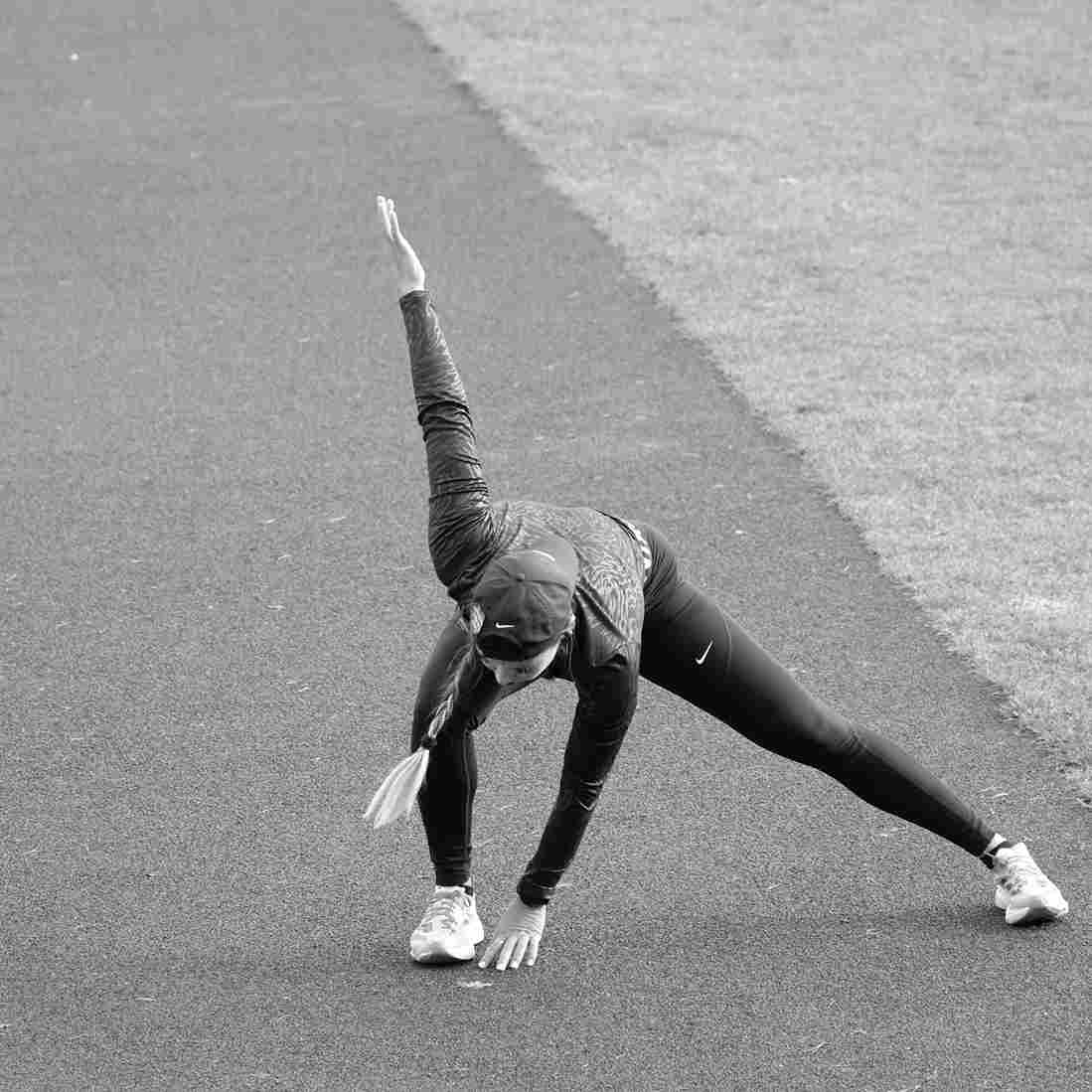 Runner tying shoes on a track